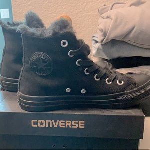 Fur lined high top suede converse.